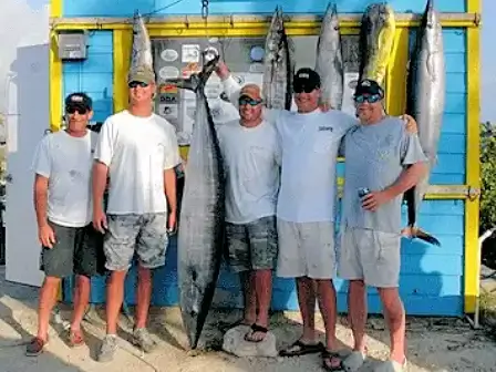Anglers on a professional charter enjoy a successful deep sea fishing experience.