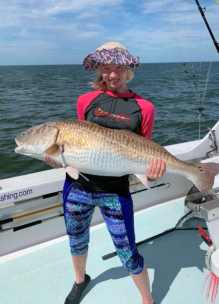 Young female angler with huge red drum caught outside Oregon Inlet, NC.