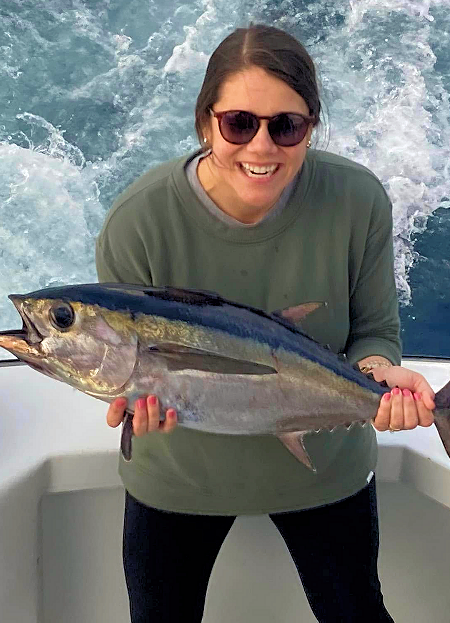 Happy young lady angler shows off her tuna caught just off Ocracoke Island.
