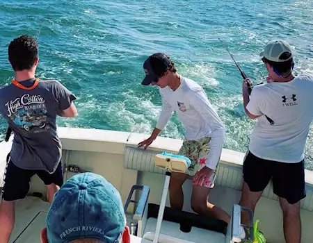 Charter group fighting red drum on a Hatteras fishing charter.
