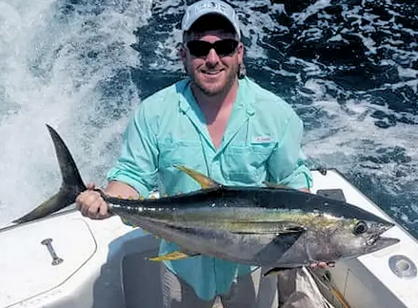 Wild Card charter customer holding a nice yellowfin tuna.